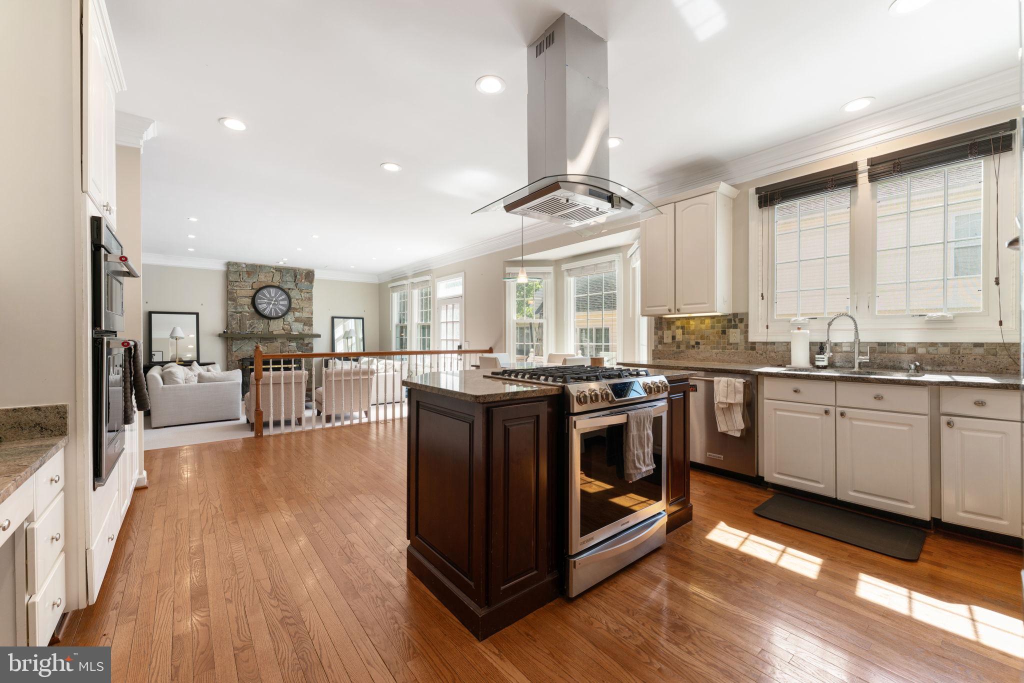 2113 Arrowleaf Drive Vienna, VA 22182 - Photo 9 of 40 a kitchen with stainless steel appliances granite countertop a stove and a wooden floors