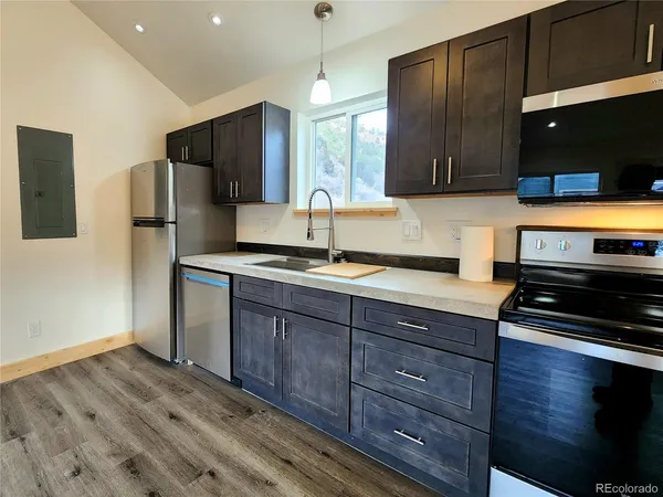 a kitchen with wooden cabinets and a wooden floors