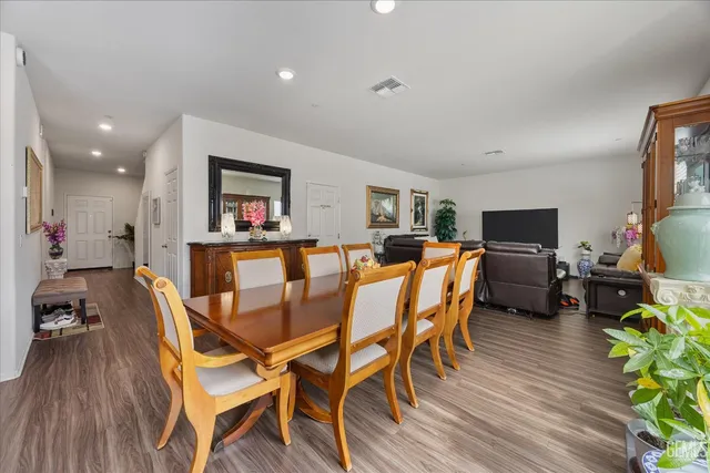 a dining room with furniture and wooden floor