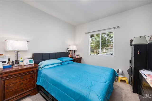 a bedroom with a bed and a lamp on table