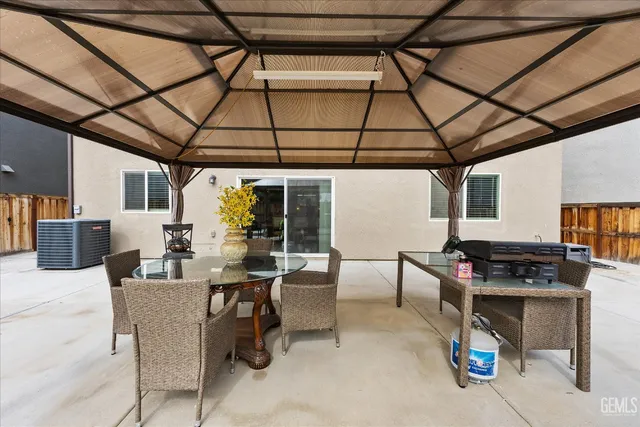 a patio with a table and chairs