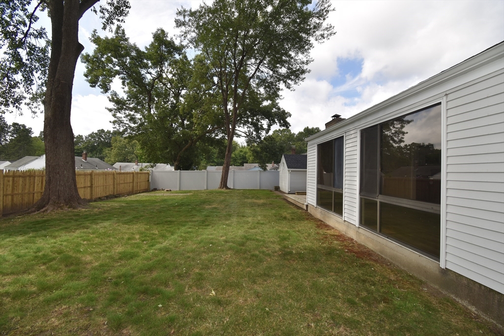 29 Kay Street Springfield, MA 01109 - Photo 5 of 41 a backyard of house with a slide and large trees