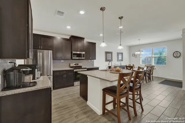 a kitchen with lots of counter top space and stainless steel appliances