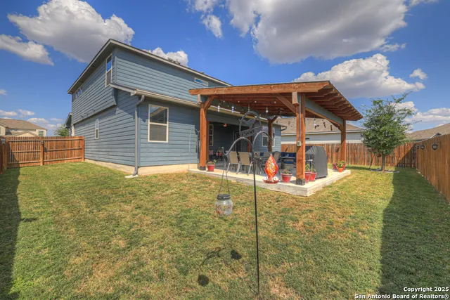 a view of a patio with couches chairs dining table and chairs with wooden floor