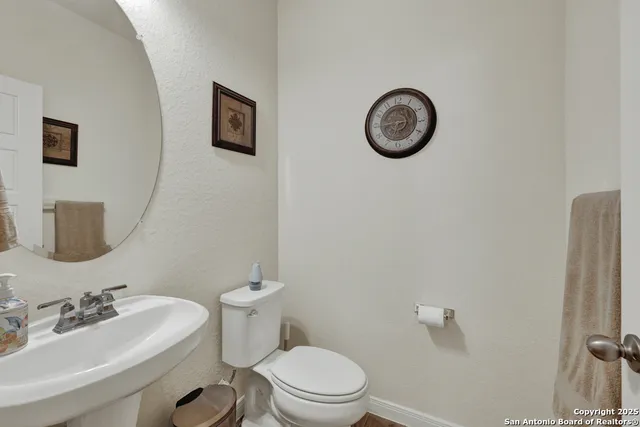 a bathroom with a toilet a sink and a mirror