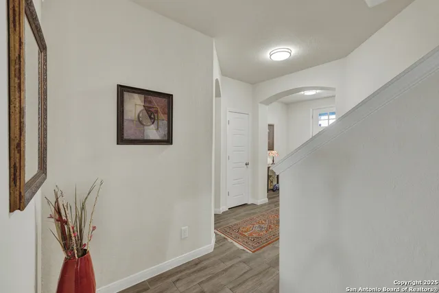 a view of hallway with wooden floor