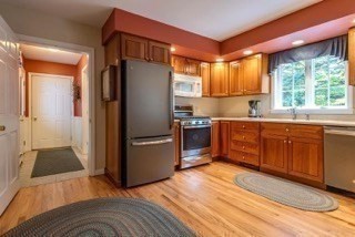 51 Tracey Cove Circle Rome, ME 04963 - Photo 11 of 25 a kitchen with stainless steel appliances granite countertop a refrigerator a sink a stove with wooden cabinets and floor
