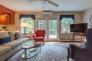 51 Tracey Cove Circle Rome, ME 04963 - Photo 13 of 25 a living room with furniture a flat screen tv and a large window