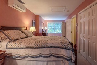 51 Tracey Cove Circle Rome, ME 04963 - Photo 18 of 25 a large bed sitting in a bedroom next to a window