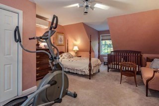 51 Tracey Cove Circle Rome, ME 04963 - Photo 20 of 25 a bedroom with a bed a lamp and a dresser