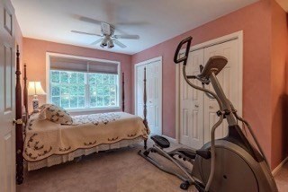 51 Tracey Cove Circle Rome, ME 04963 - Photo 21 of 25 a bed sitting in a bedroom next to a window