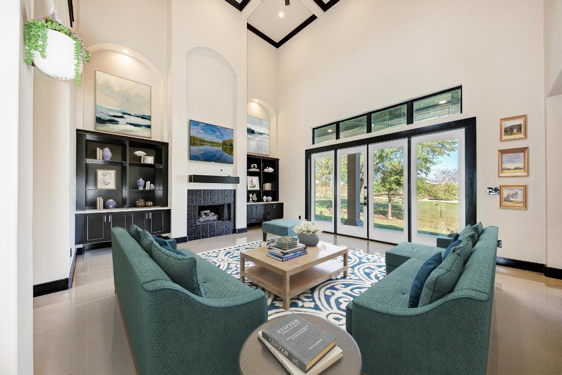 104 Spring Valley Street Hutto, TX 78634 - Photo 11 of 40 a living room with furniture flat screen tv and a large window