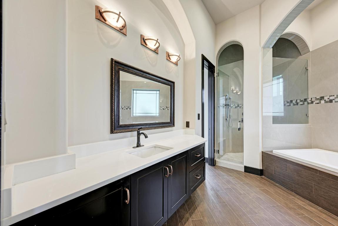 104 Spring Valley Street Hutto, TX 78634 - Photo 16 of 40 a bathroom with double vanity sinks and a bathtub