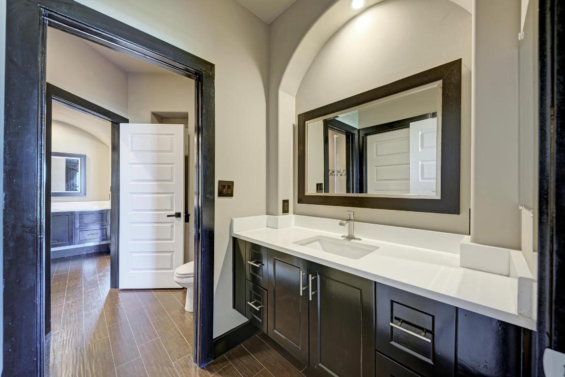 104 Spring Valley Street Hutto, TX 78634 - Photo 30 of 40 a bathroom with a sink and a mirror