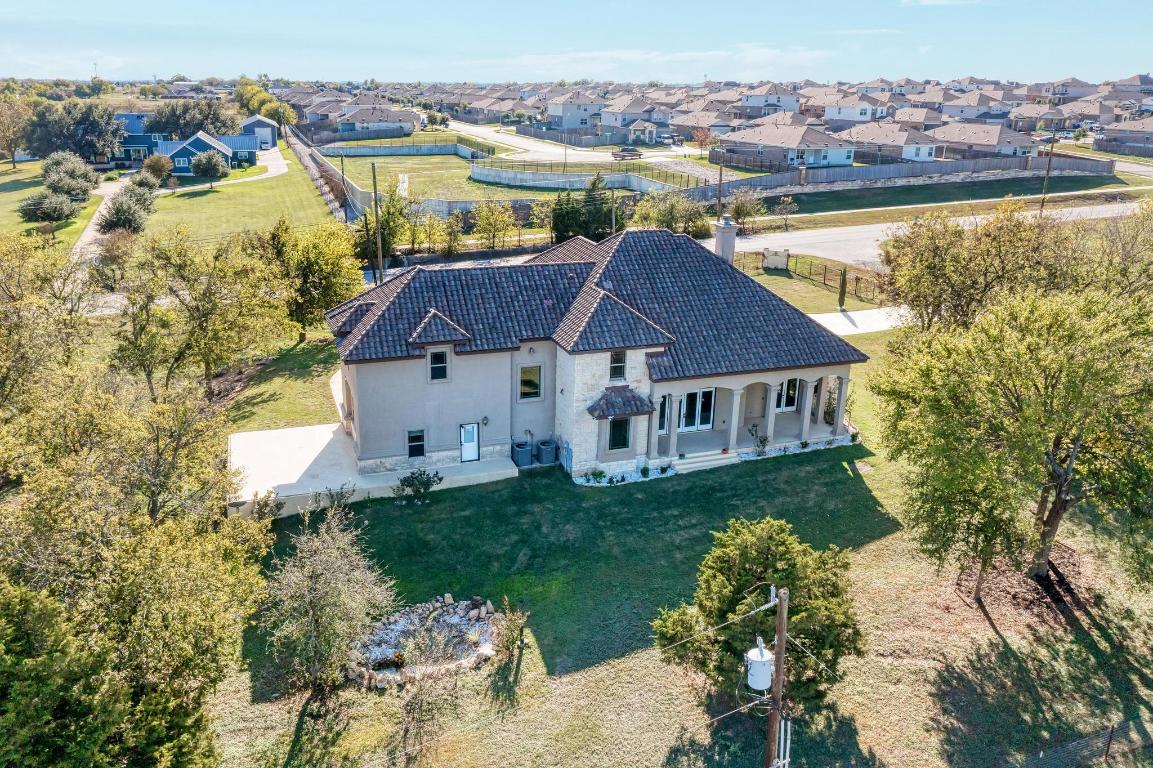 104 Spring Valley Street Hutto, TX 78634 - Photo 36 of 40 a aerial view of a house with swimming pool and ocean view