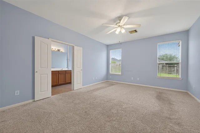 a view of an empty room with a fan