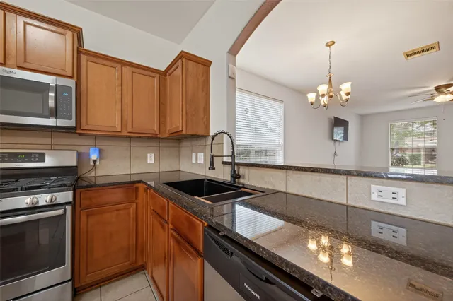 a kitchen with a counter top space and appliances