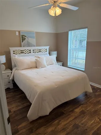 a large bed sitting in a bedroom next to a window