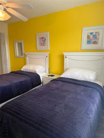 a bedroom with a bed and painting on the wall