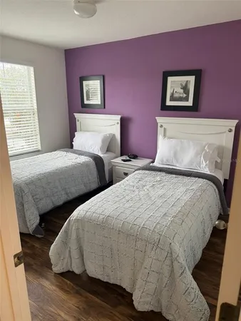 a large bed sitting in a bedroom next to a window