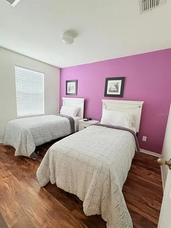 a bedroom with two beds and a couch