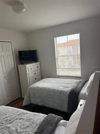 a bedroom with a bed and a television