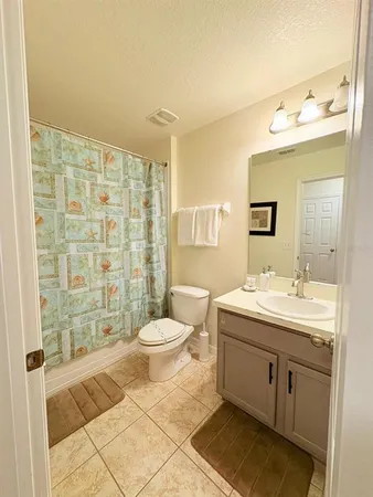 a bathroom with a double vanity sink mirror and toilet