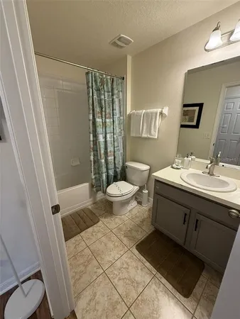 a bathroom with a sink a toilet a mirror and shower