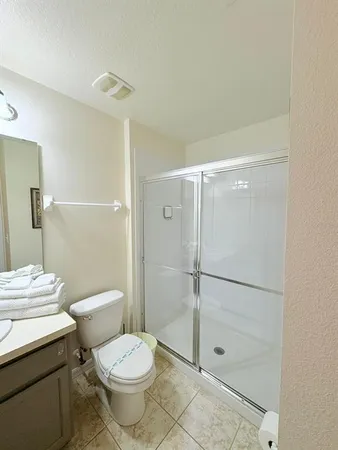 a bathroom with a toilet and a shower