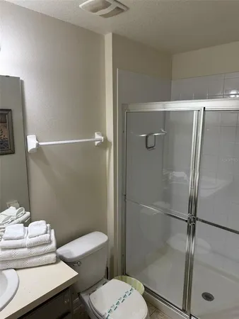 a bathroom with a toilet and a shower