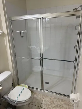 a bathroom with a toilet and a shower