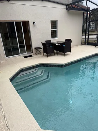 a view of kitchen island with stainless steel appliances granite countertop sink and stove