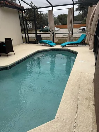 a view of swimming pool with a lounge chair
