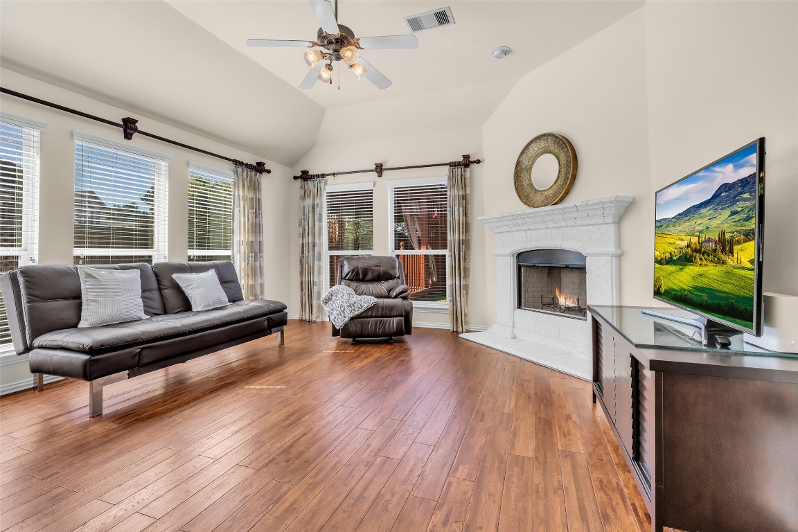 10022 Darrell Springs Lane Tomball, TX 77375 - Photo 11 of 27 a living room with furniture a flat screen tv and a fireplace
