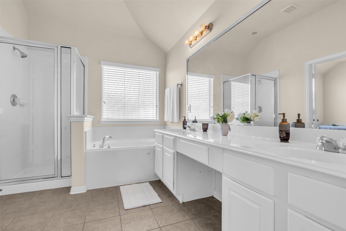 10022 Darrell Springs Lane Tomball, TX 77375 - Photo 14 of 27 a bathroom with a tub sink and mirror