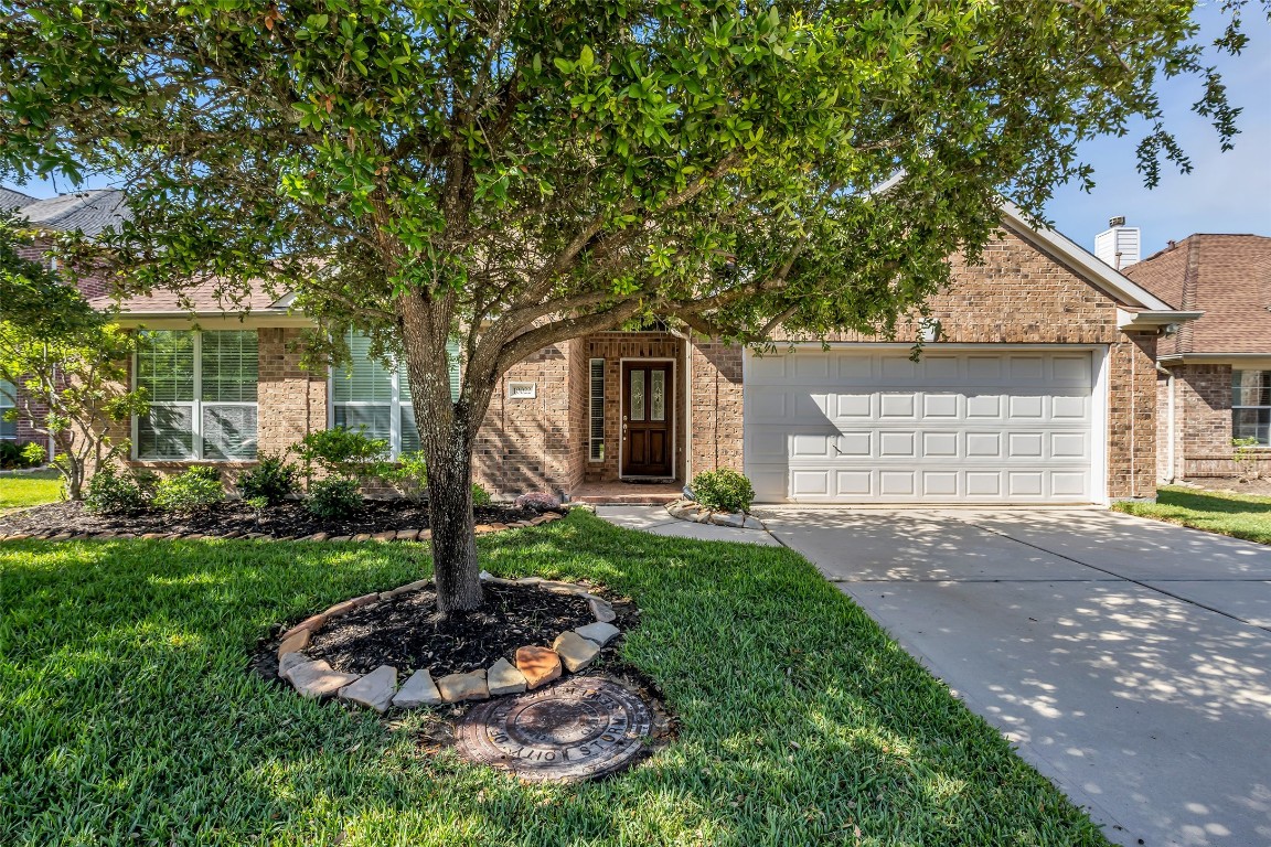 10022 Darrell Springs Lane Tomball, TX 77375 - Photo 2 of 27 a front view of a house with a yard and garage