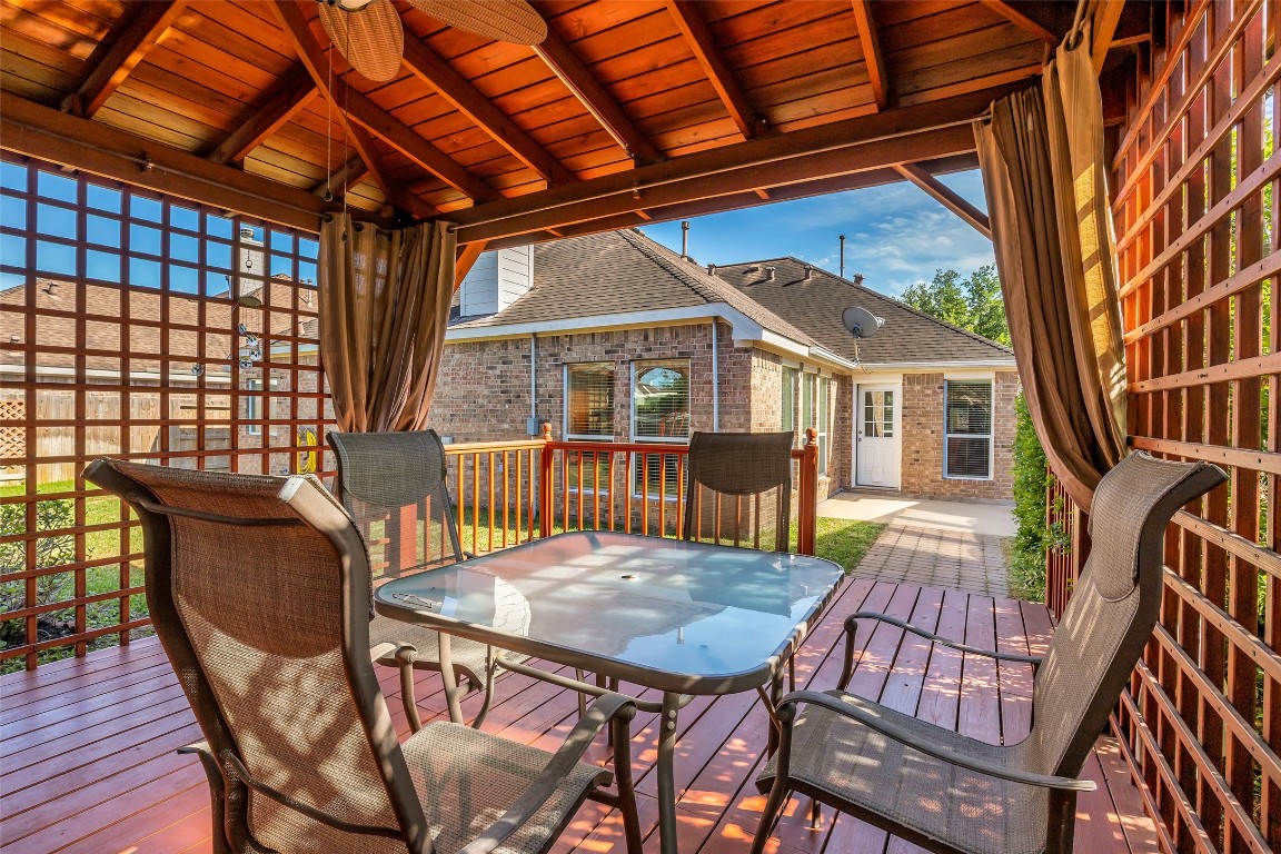 10022 Darrell Springs Lane Tomball, TX 77375 - Photo 22 of 27 a view of a patio with a table and chairs