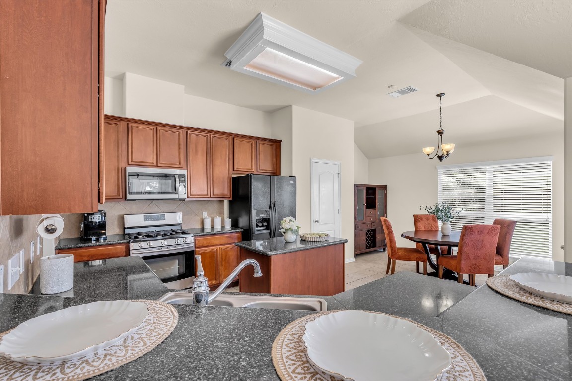 10022 Darrell Springs Lane Tomball, TX 77375 - Photo 4 of 27 a dining room with furniture a window and kitchen view