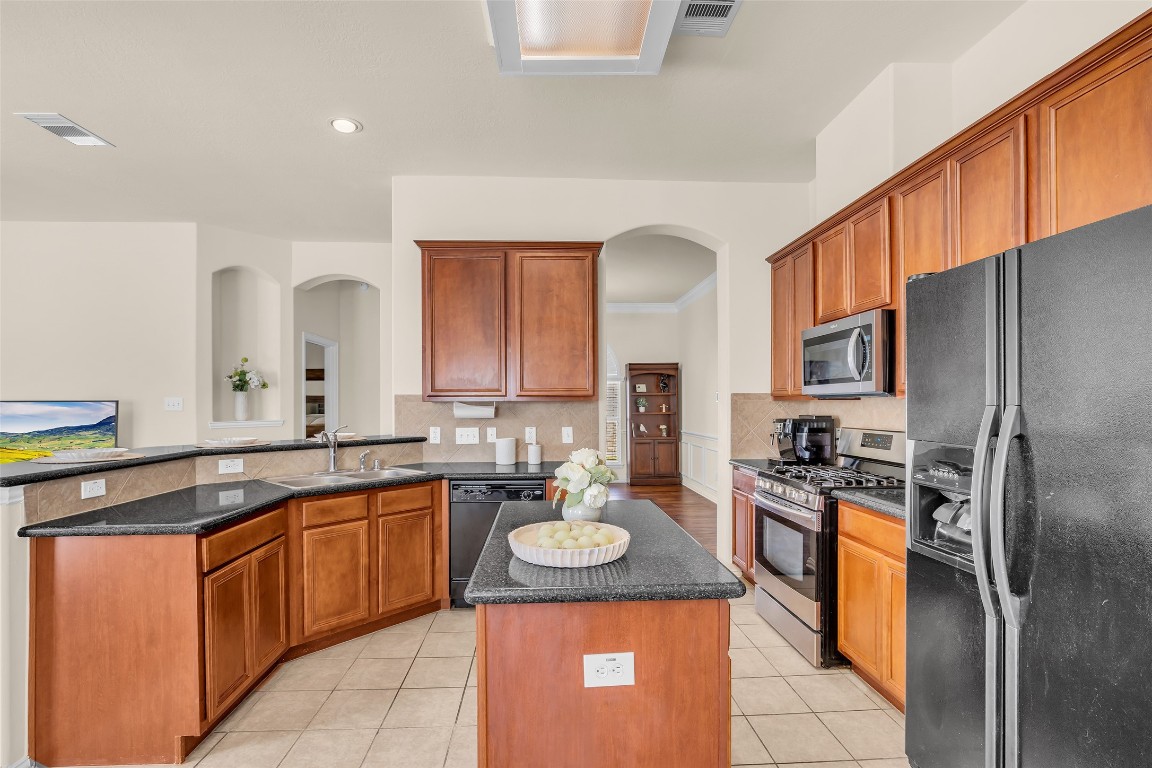 10022 Darrell Springs Lane Tomball, TX 77375 - Photo 6 of 27 a kitchen with a sink stove and refrigerator