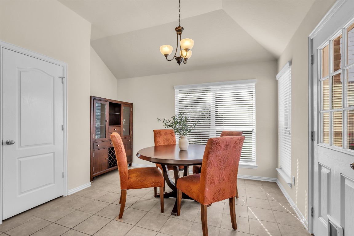 10022 Darrell Springs Lane Tomball, TX 77375 - Photo 9 of 27 a dining room with furniture a chandelier and window