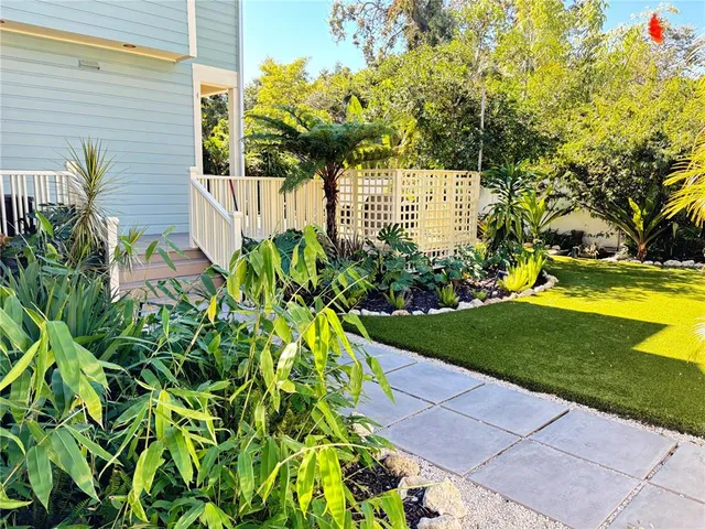 a view of a dining room and livingroom with furniture wooden floor a chandelier