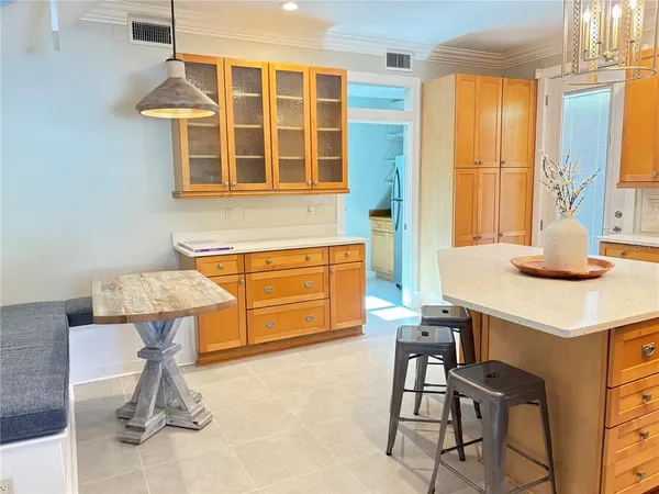 a kitchen with a sink cabinets and dining table