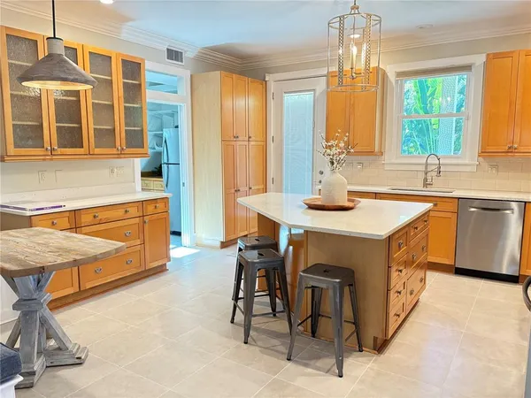 a kitchen with stainless steel appliances granite countertop a stove a sink and a refrigerator