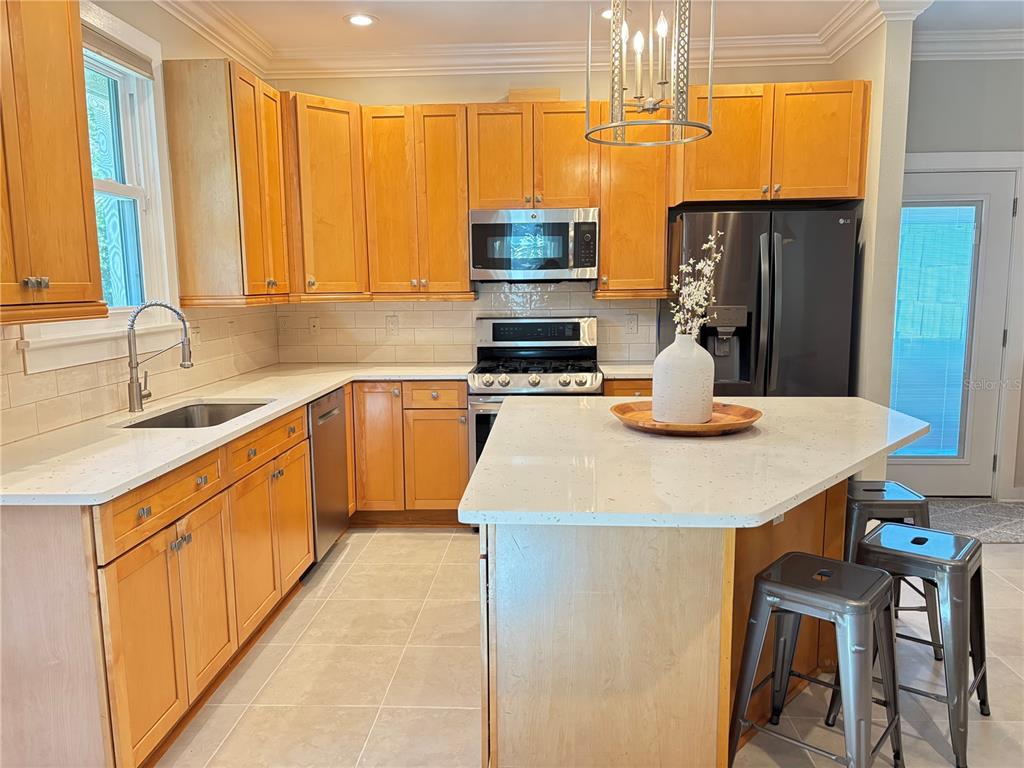 324 Julia Place Sarasota, FL 34236 - Photo 17 of 52 a kitchen with kitchen island granite countertop a sink stainless steel appliances cabinets and a counter top space