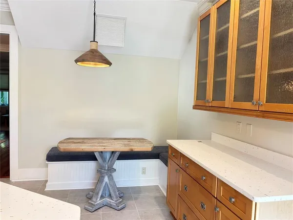 a room with a table and chandelier