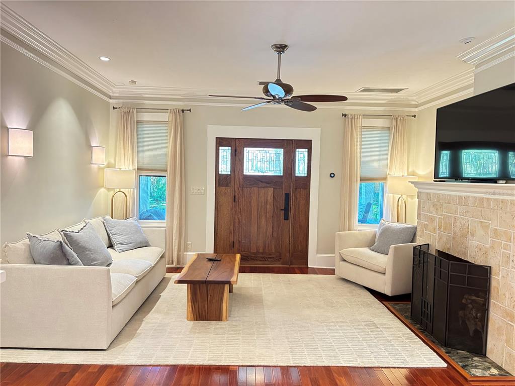 324 Julia Place Sarasota, FL 34236 - Photo 26 of 52 a living room with furniture a fireplace and a flat screen tv