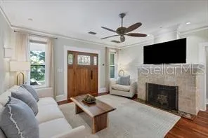 a living room with furniture a fireplace and a flat screen tv
