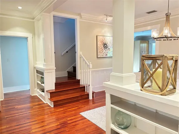 a view of entryway and hall with wooden floor