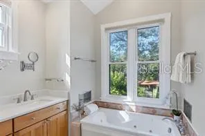 a bathroom with a tub sink and window