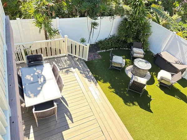 a balcony with dining table and chairs